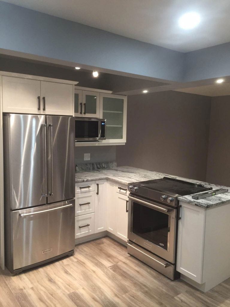 a newly renovated kitchen with stainless steel appliances