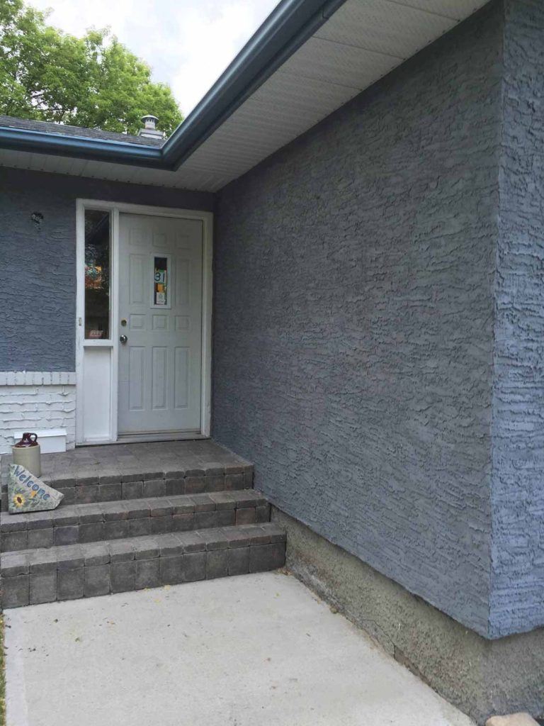Exterior blue stucco in knockdown style